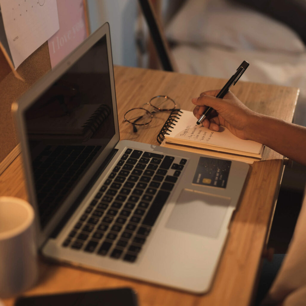 hand-writing-notebook-laptop